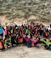 School group doing beach conservation